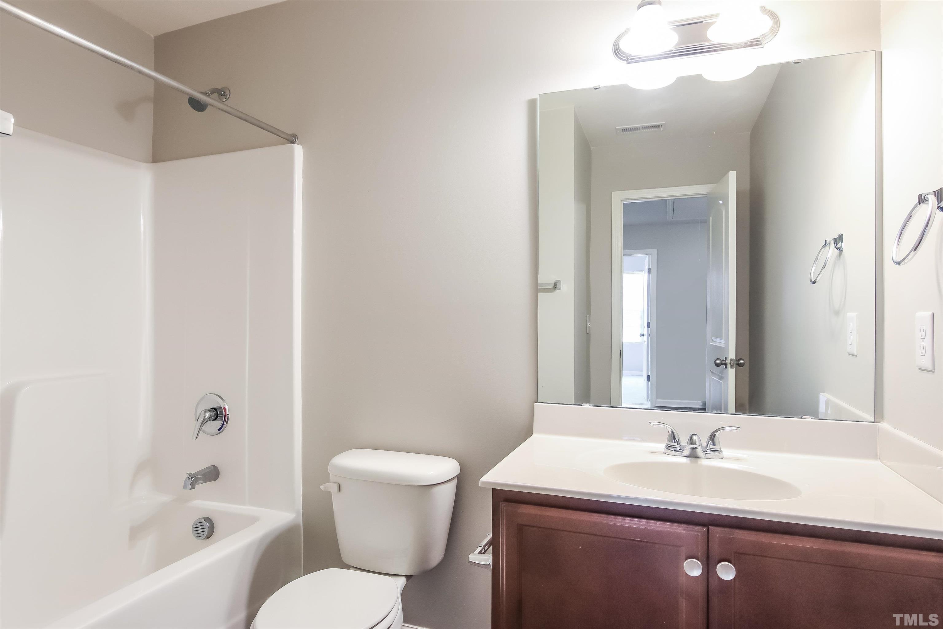 333 Sequoia Drive Clayton, NC 27527 - Photo 16 of 17 a bathroom with a sink and a mirror