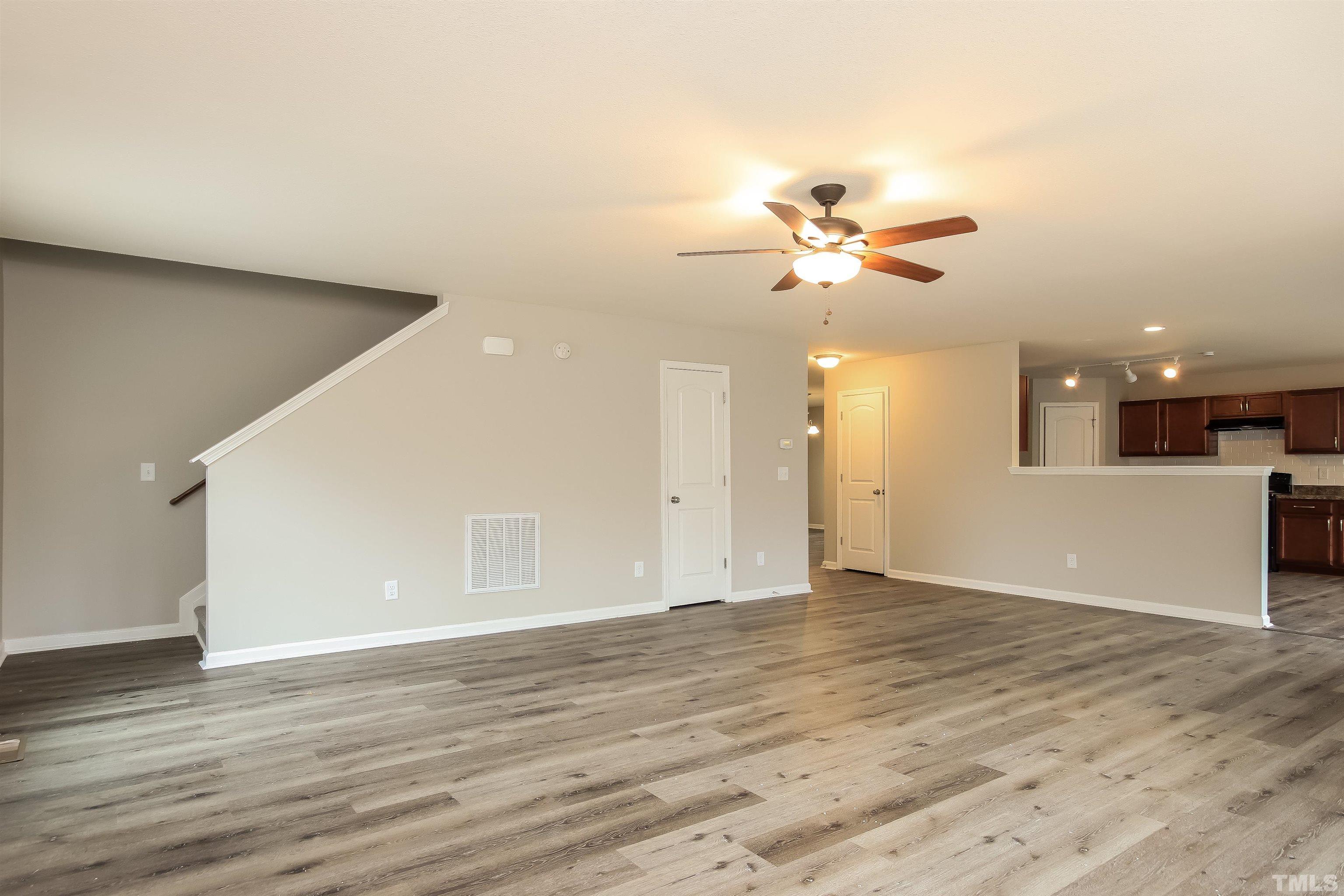 333 Sequoia Drive Clayton, NC 27527 - Photo 5 of 17 a view of a big room with wooden floor and a ceiling fan