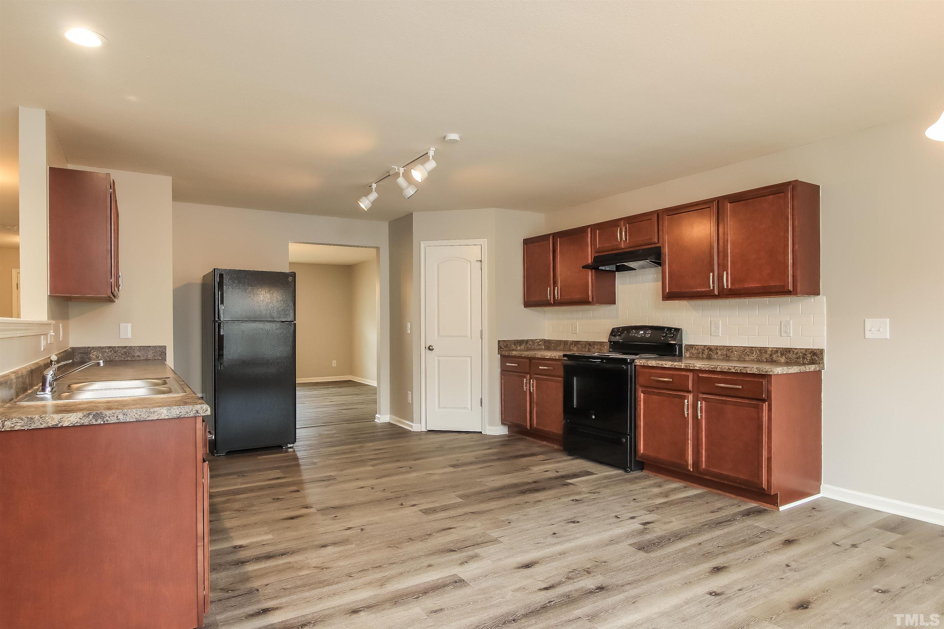 333 Sequoia Drive Clayton, NC 27527 - Photo 7 of 17 a kitchen with stainless steel appliances granite countertop a refrigerator stove and sink