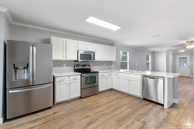 a kitchen with a stove top oven and refrigerator