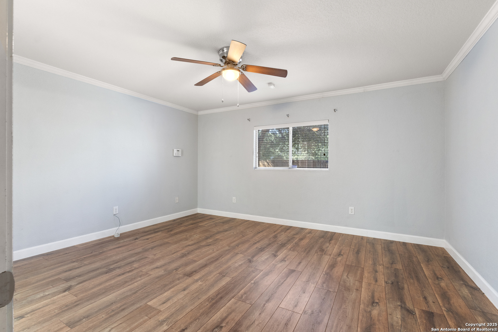 8119 Running Hollow Selma, TX 78154 - Photo 16 of 33 an empty room with wooden floor ceiling fan and window