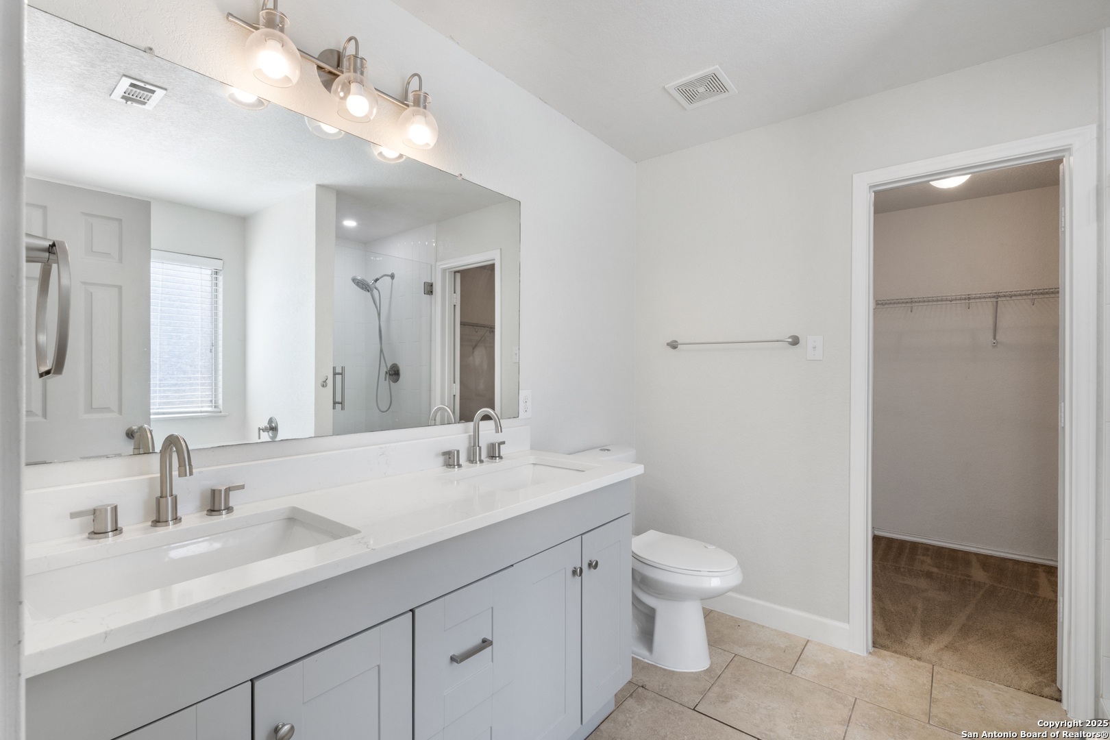 8119 Running Hollow Selma, TX 78154 - Photo 17 of 33 a bathroom with a granite countertop sink a toilet and a mirror