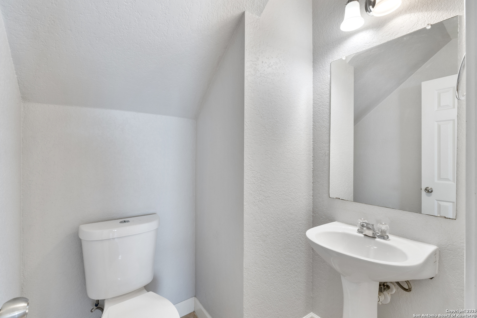 8119 Running Hollow Selma, TX 78154 - Photo 19 of 33 a bathroom with a toilet sink and mirror