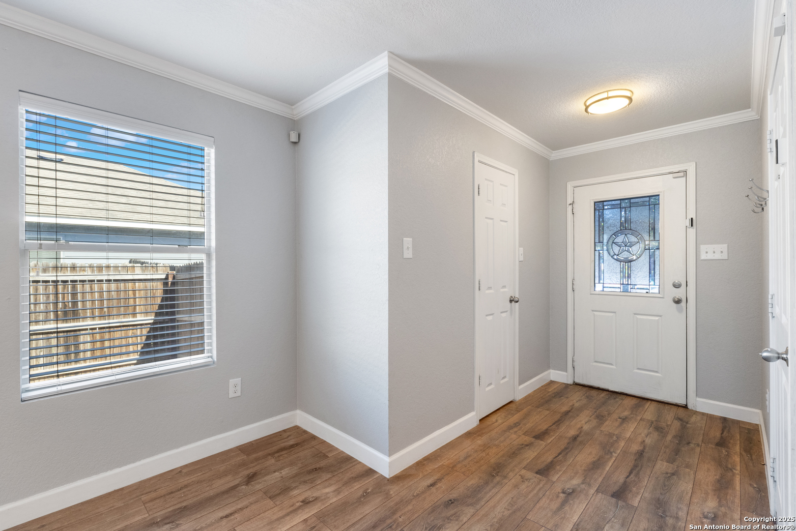 8119 Running Hollow Selma, TX 78154 - Photo 27 of 33 a view of an empty room with wooden floor and a window