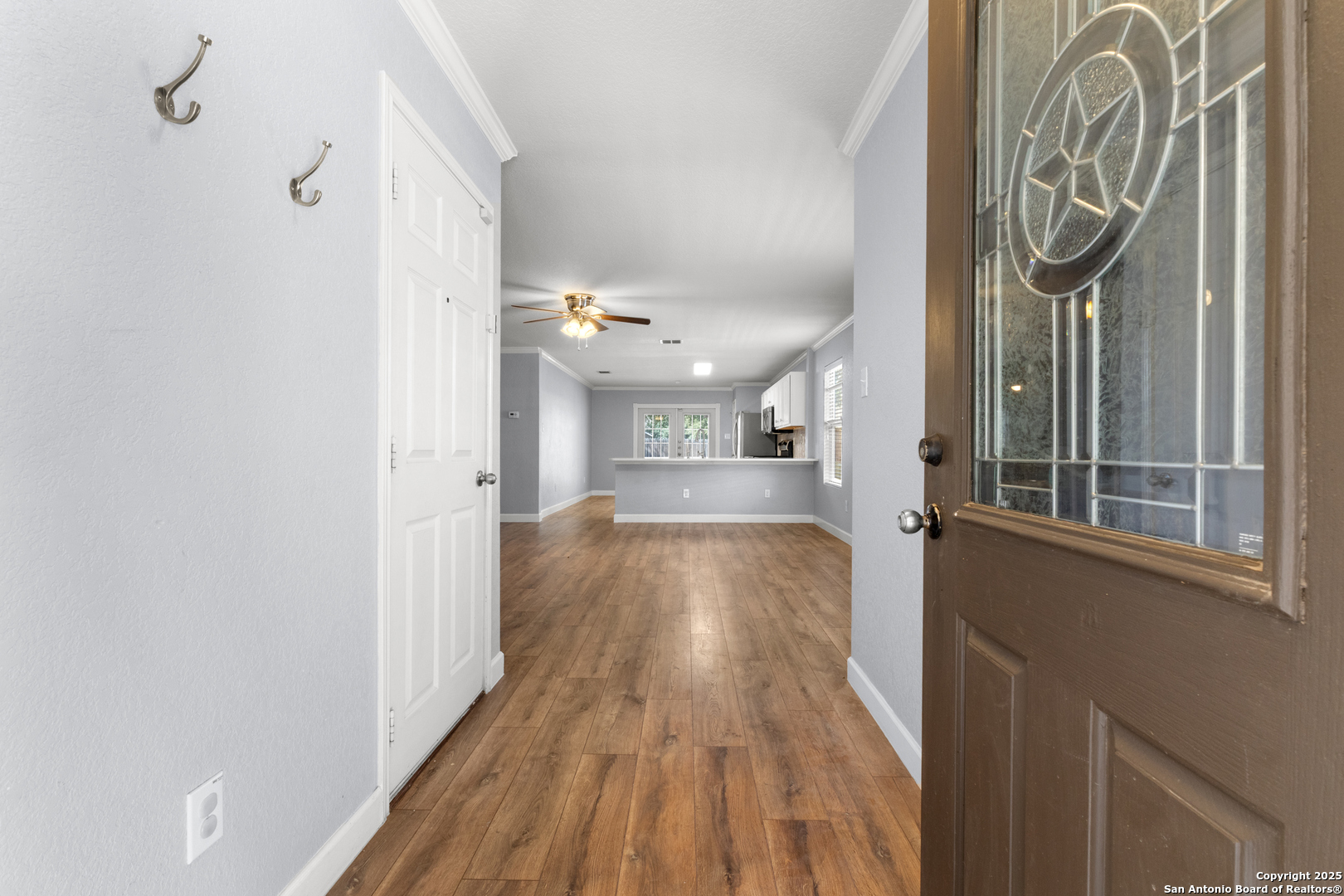 8119 Running Hollow Selma, TX 78154 - Photo 7 of 33 a view of a hallway with wooden floor and staircase