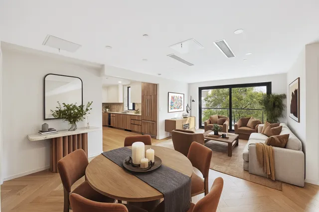 a living room with furniture potted plant and a large window