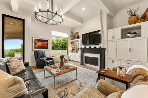 a living room with furniture a flat screen tv and a fireplace