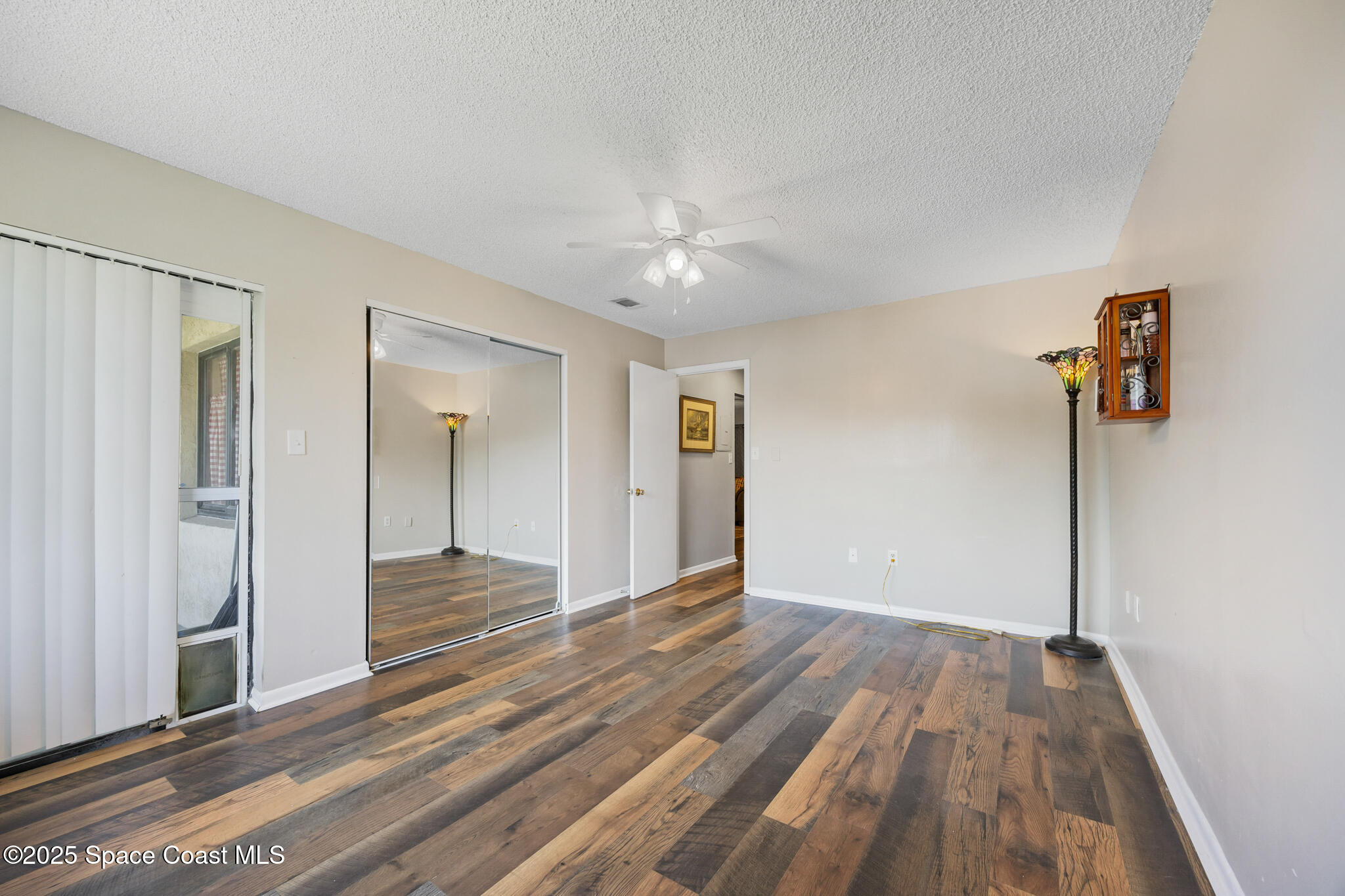 1515 Huntington Lane, Unit 227 Rockledge, FL 32955 - Photo 12 of 14 a view of a room with wooden floor and a ceiling fan