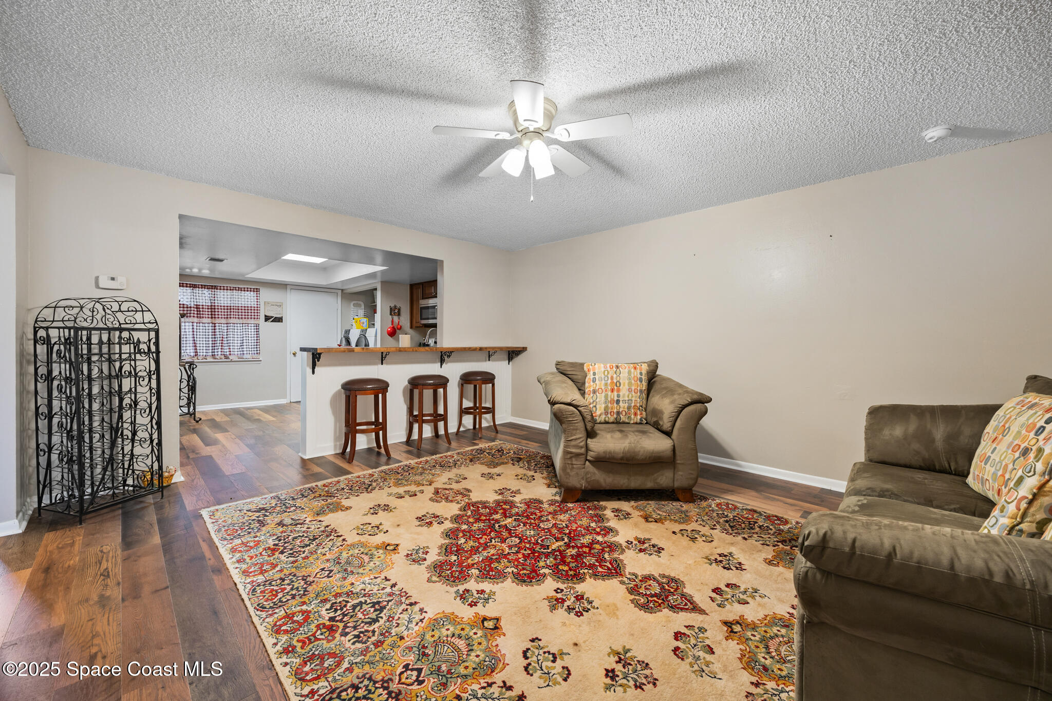 1515 Huntington Lane, Unit 227 Rockledge, FL 32955 - Photo 3 of 14 a living room with furniture and wooden floor