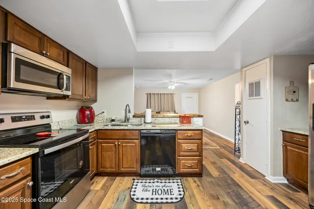 a kitchen with stainless steel appliances a stove sink microwave and cabinets