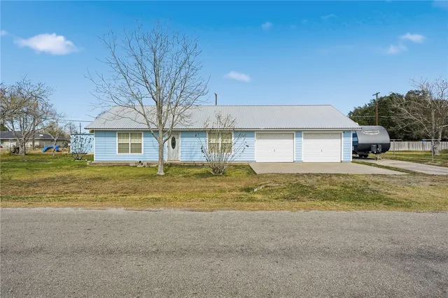 a view of a house with a swimming pool next to a yard