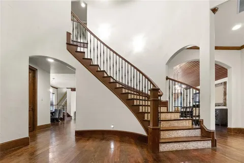 a view of entryway and hall with wooden floor