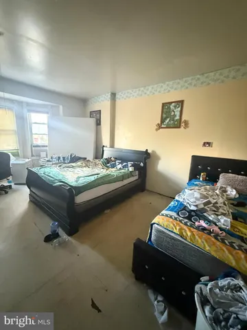 a bedroom with bed and window