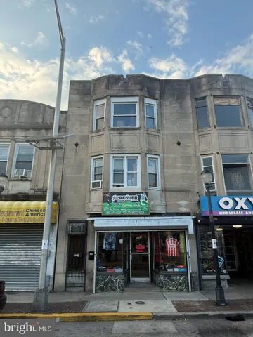 a front view of a building with sitting area