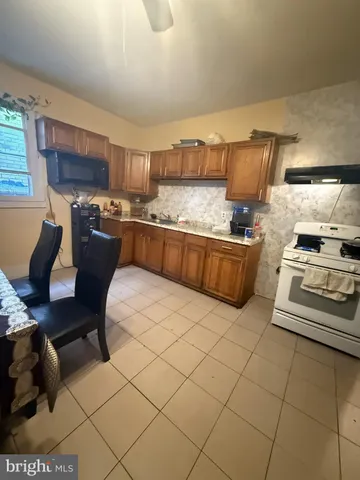 a kitchen with stainless steel appliances kitchen island granite countertop a sink and cabinets