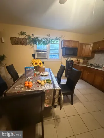 a living room with furniture a flat screen tv and a floor to ceiling window