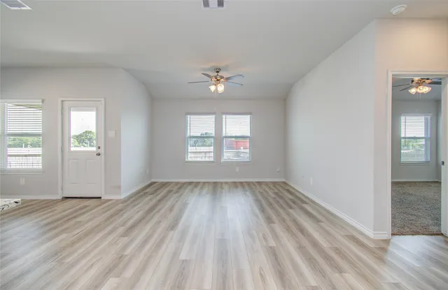 wooden floor in an empty room with a window