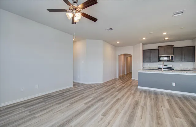 a view of kitchen with refrigerator microwave and cabinets