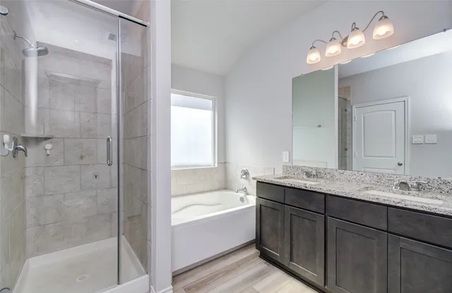 a bathroom with a bathtub a sink and a mirror