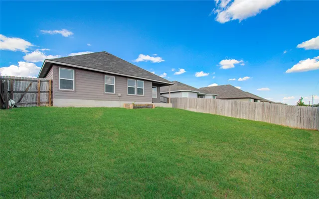 a backyard of a house with lots of green space