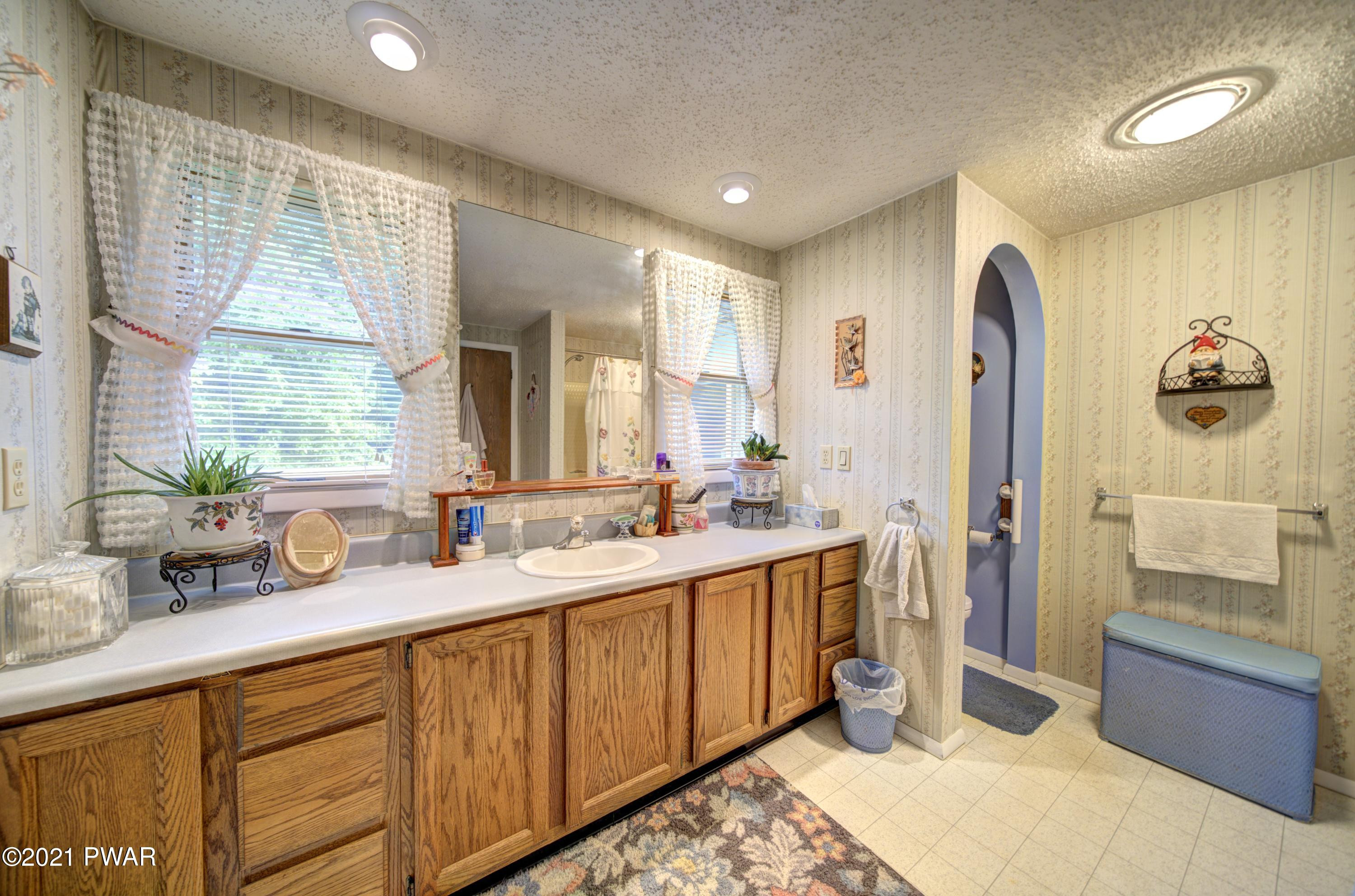 368 Roemerville Road Greentown, PA 18426 - Photo 41 of 59 a spacious bathroom with a double vanity sink and a mirror