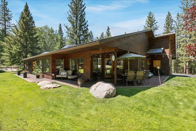 a view of a house with backyard porch and sitting area