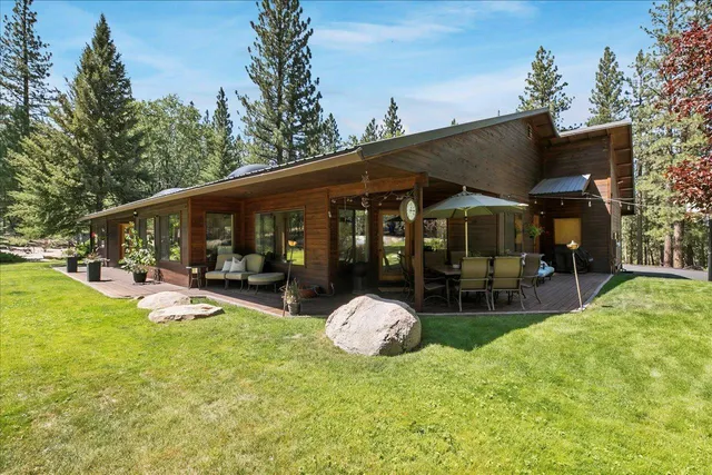 a view of a house with backyard porch and sitting area