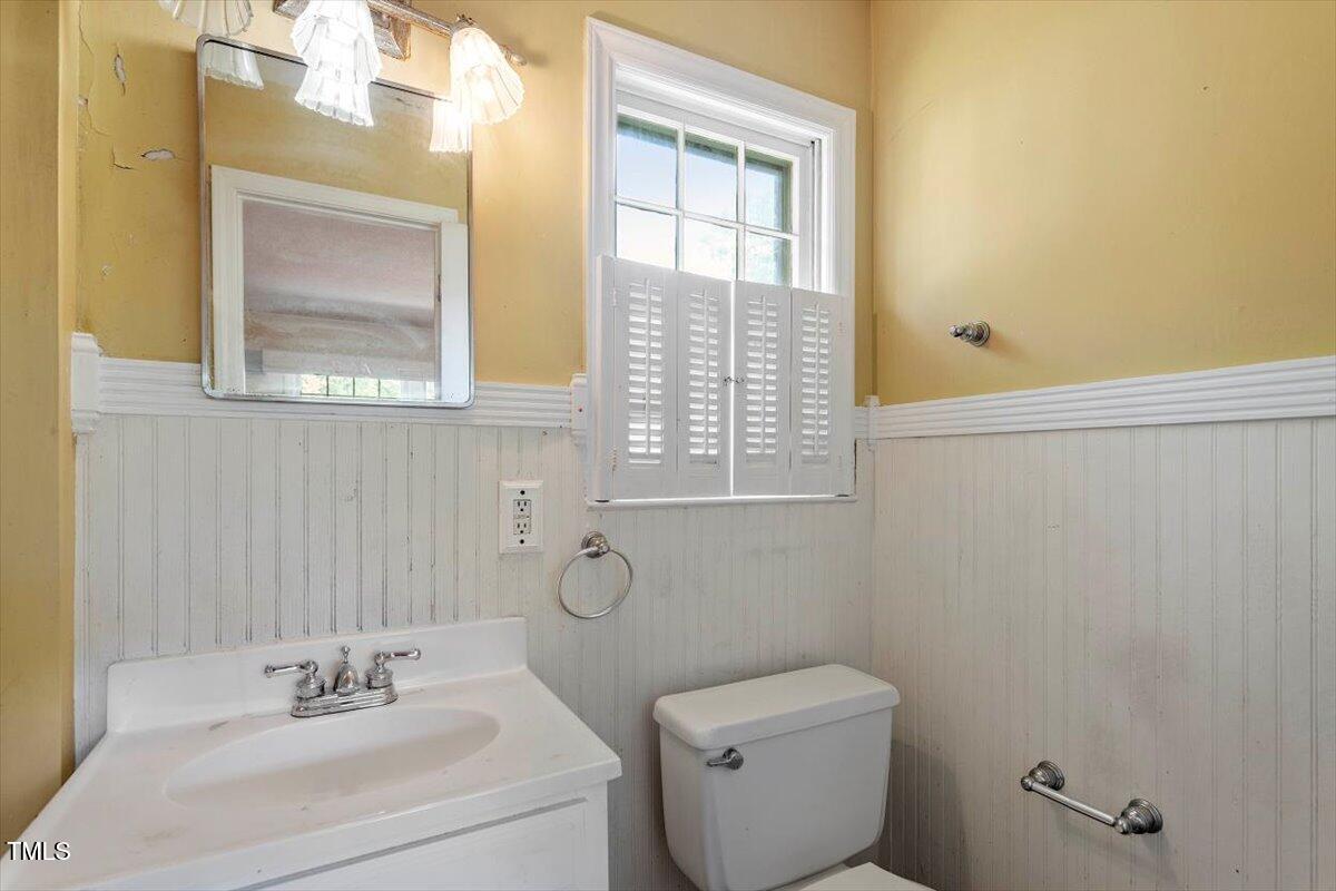 2343 Derby Drive Raleigh, NC 27610 - Photo 14 of 28 a bathroom with a sink a toilet and a mirror