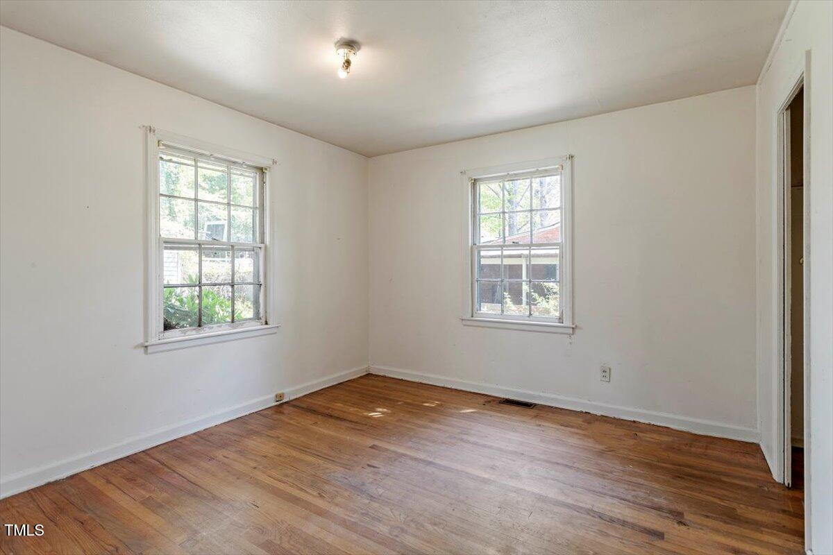 2343 Derby Drive Raleigh, NC 27610 - Photo 15 of 28 a view of empty room with wooden floor and fan