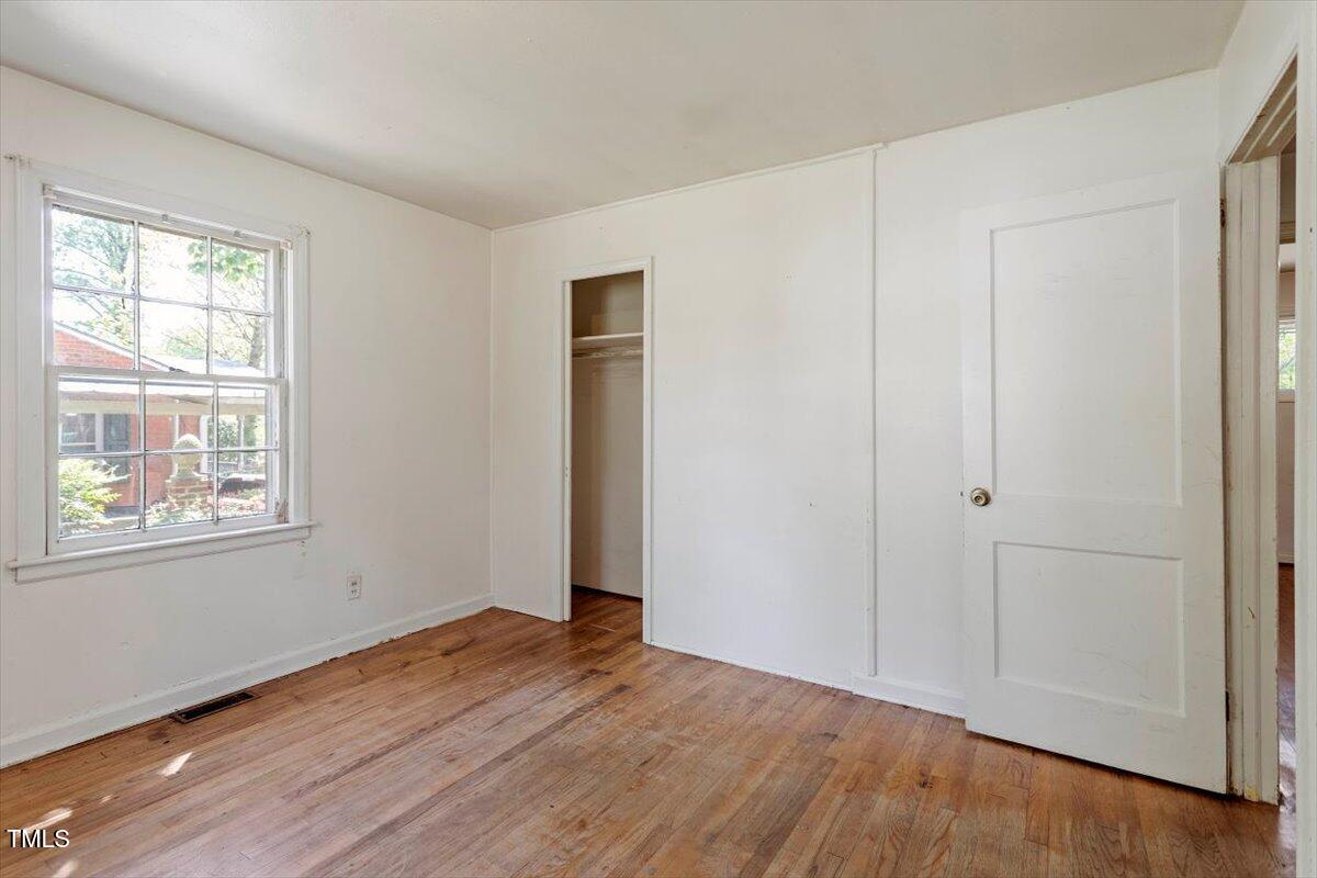 2343 Derby Drive Raleigh, NC 27610 - Photo 16 of 28 a view of an empty room with wooden floor and a window