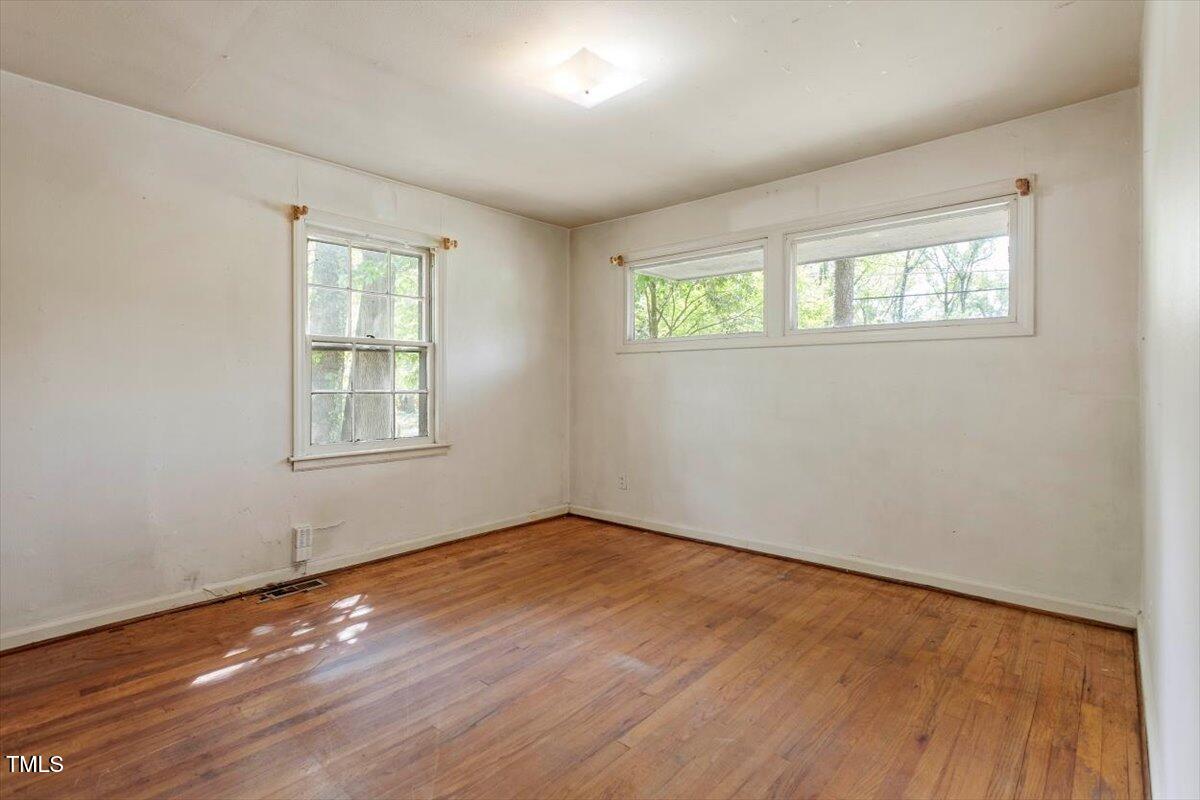 2343 Derby Drive Raleigh, NC 27610 - Photo 18 of 28 an empty room with wooden floor and windows