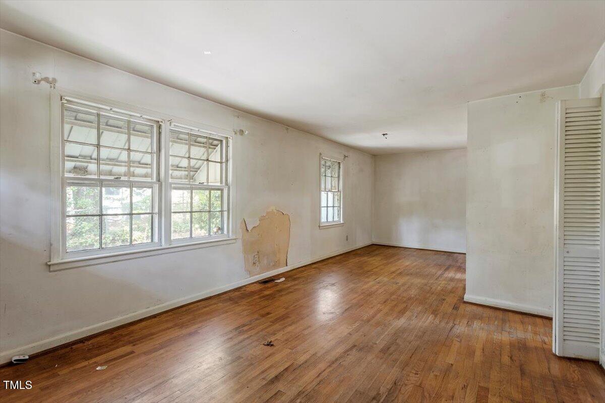 2343 Derby Drive Raleigh, NC 27610 - Photo 4 of 28 an empty room with wooden floor and windows