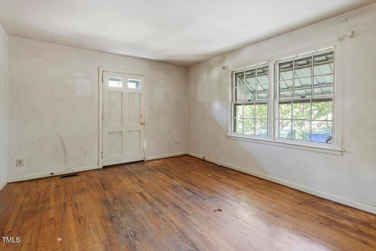 2343 Derby Drive Raleigh, NC 27610 - Photo 5 of 28 an empty room with wooden floor and windows