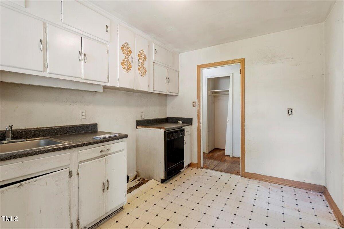 2343 Derby Drive Raleigh, NC 27610 - Photo 9 of 28 a kitchen with granite countertop white cabinets and white appliances