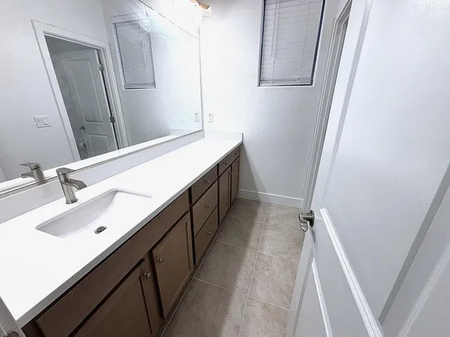 a bathroom with a double vanity sink a and mirror