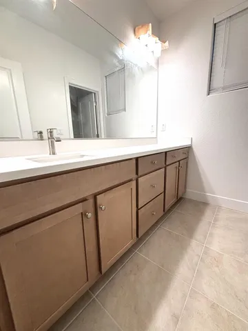 a spacious bathroom with a double vanity sink and a mirror