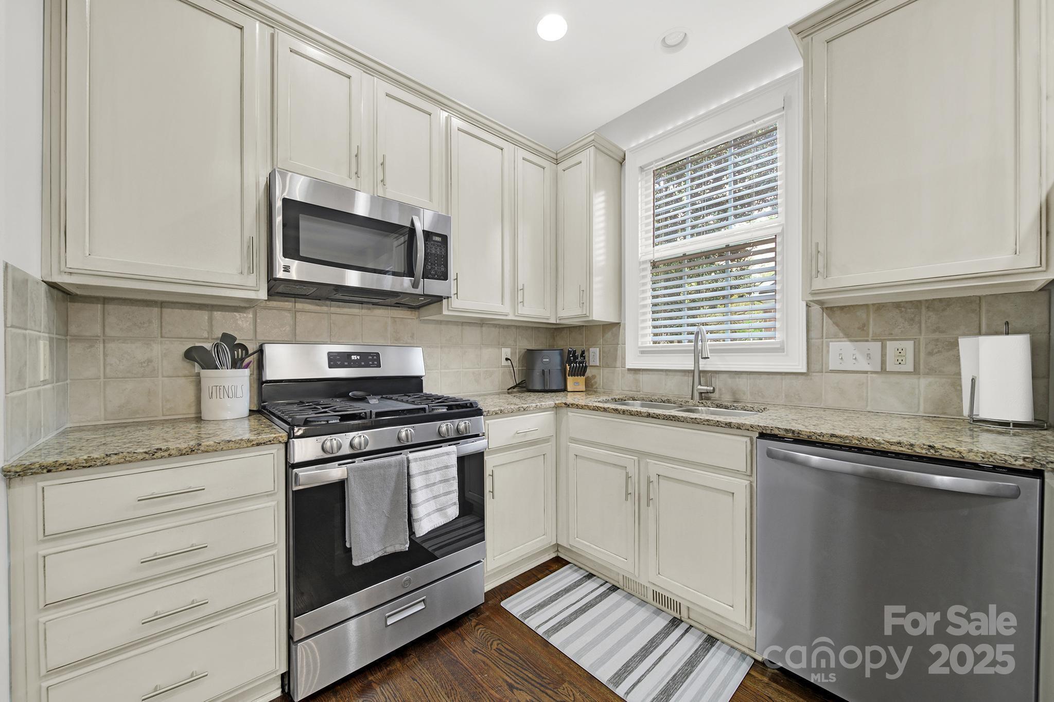 110 Sonnys Way Fort Mill, SC 29708 - Photo 17 of 48 a kitchen with stainless steel appliances granite countertop a stove a sink and a microwave