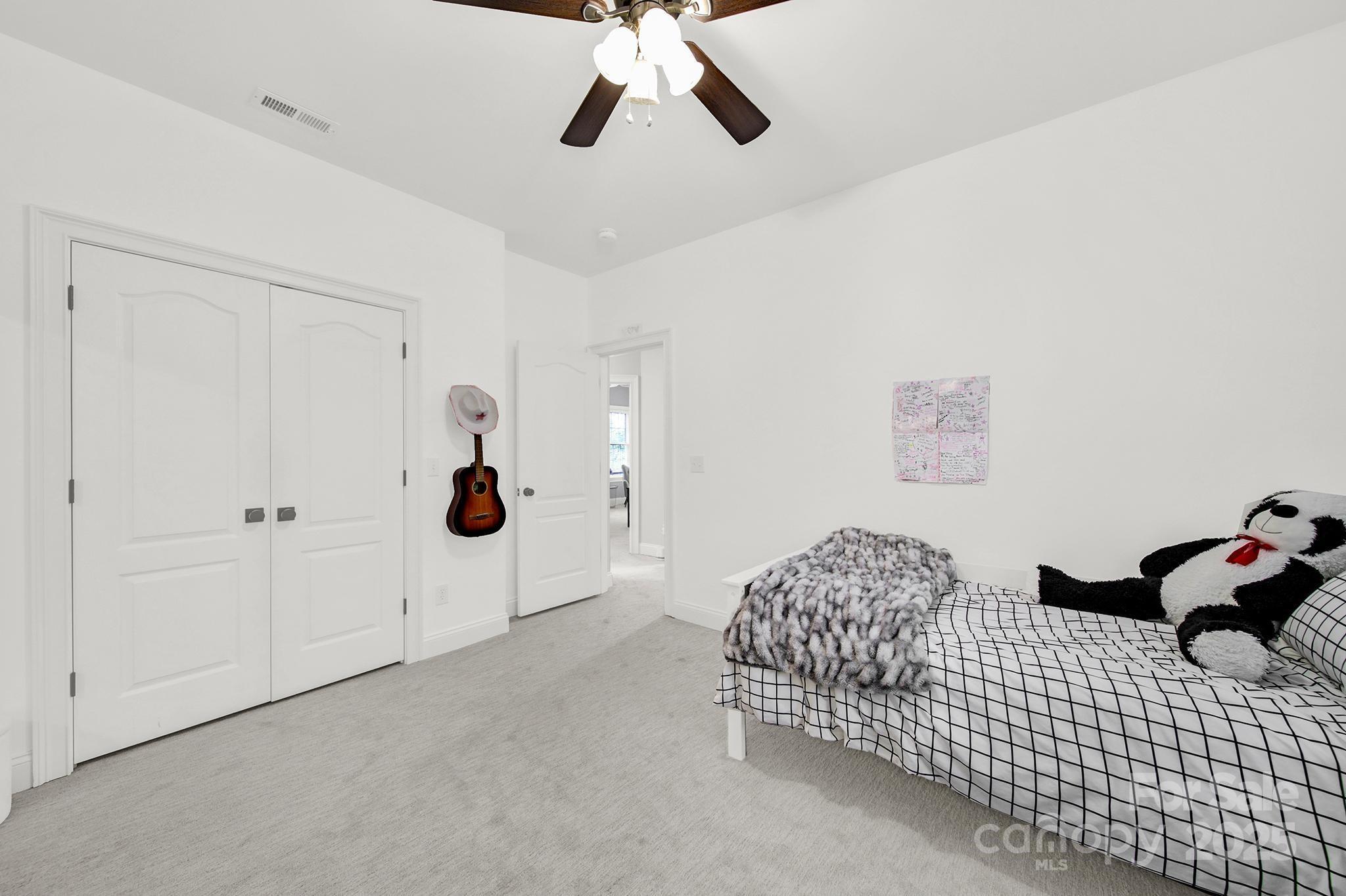 110 Sonnys Way Fort Mill, SC 29708 - Photo 23 of 48 a bedroom with a bed and a chandelier