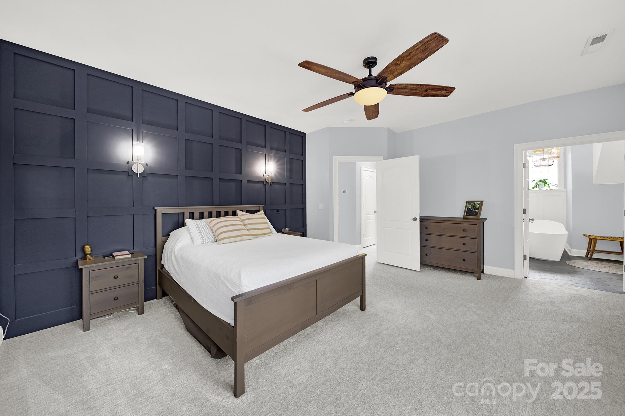 110 Sonnys Way Fort Mill, SC 29708 - Photo 30 of 48 a spacious bedroom with a bed and a chandelier