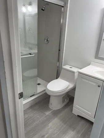 a white toilet sitting next to a bathroom sink