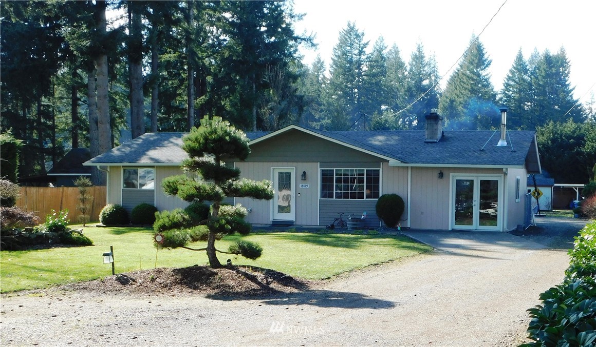 18419 Nutmeg Street Southwest Rochester, WA 98579 - Photo 2 of 24 a front view of a house with a garden and yard