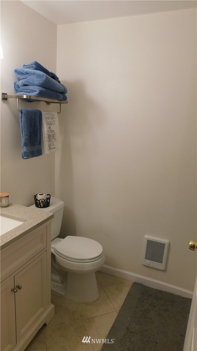 18419 Nutmeg Street Southwest Rochester, WA 98579 - Photo 12 of 24 a bathroom with a granite countertop toilet and a sink