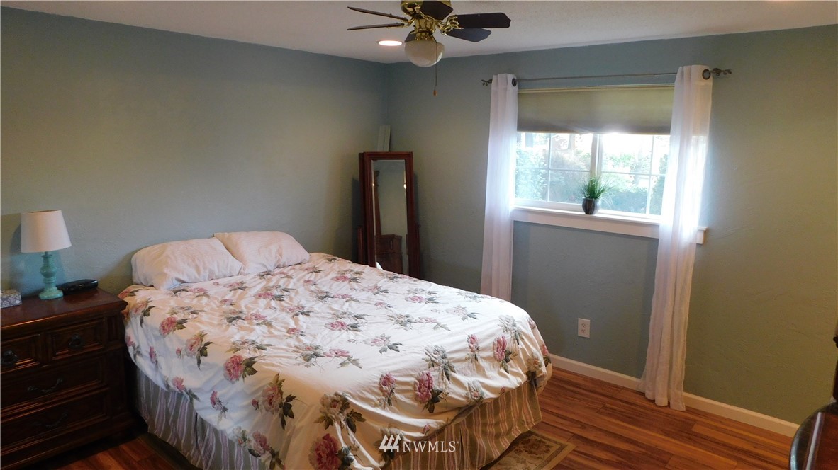 18419 Nutmeg Street Southwest Rochester, WA 98579 - Photo 13 of 24 a bedroom with a bed and a window
