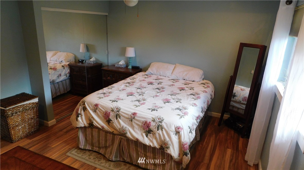 18419 Nutmeg Street Southwest Rochester, WA 98579 - Photo 14 of 24 a bedroom with a bed and a mirror on dresser