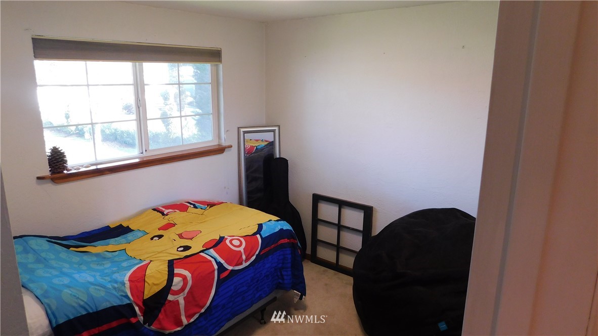 18419 Nutmeg Street Southwest Rochester, WA 98579 - Photo 17 of 24 a bedroom with a bed and a window