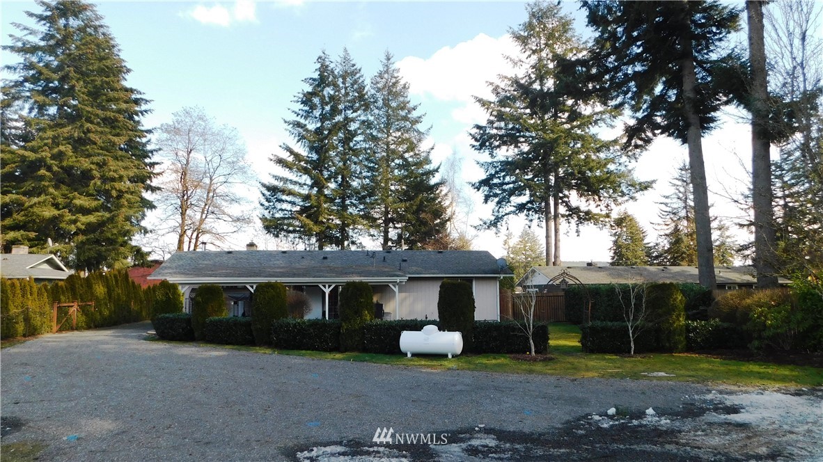 18419 Nutmeg Street Southwest Rochester, WA 98579 - Photo 20 of 24 a view of a house with backyard and trees