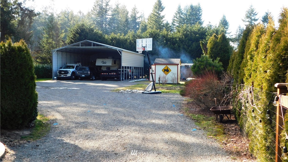 18419 Nutmeg Street Southwest Rochester, WA 98579 - Photo 21 of 24 a view of a house with backyard and trees