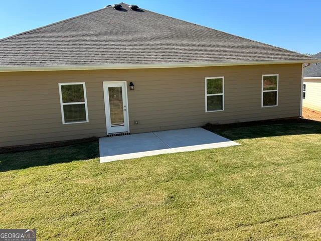 a view of a livingroom with a ceiling fan and window