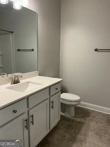 a kitchen with kitchen island granite countertop a sink cabinets and stainless steel appliances