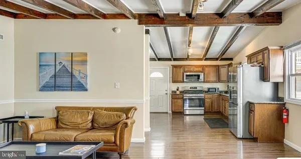 a living room with stainless steel appliances kitchen island granite countertop furniture and a kitchen view